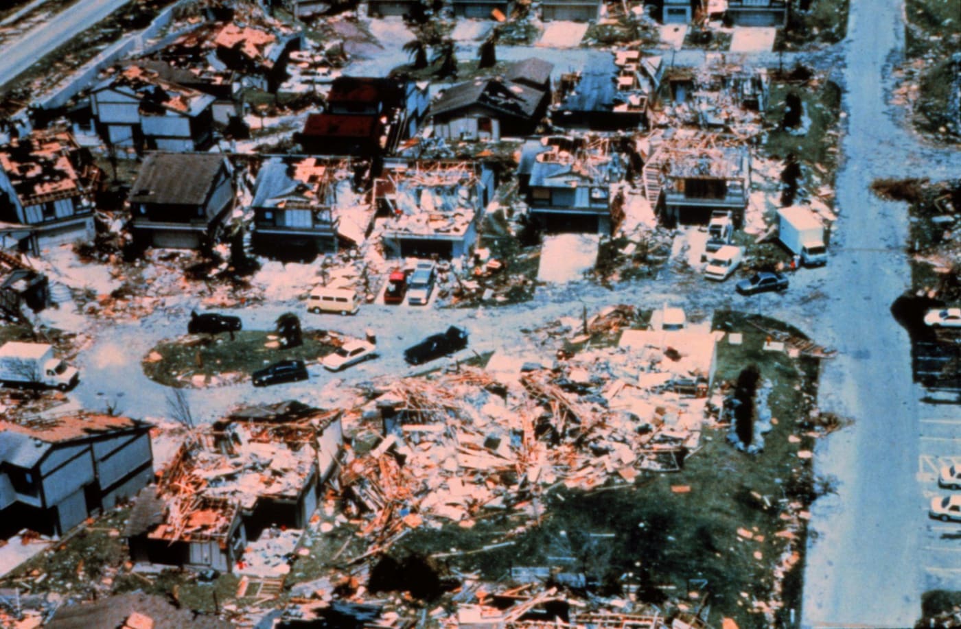 Aerial view of a Dade County street after Hurricane Andrew: some roofs held, some did not