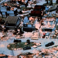 Aerial view of a Dade County street after Hurricane Andrew: some roofs held, some did not